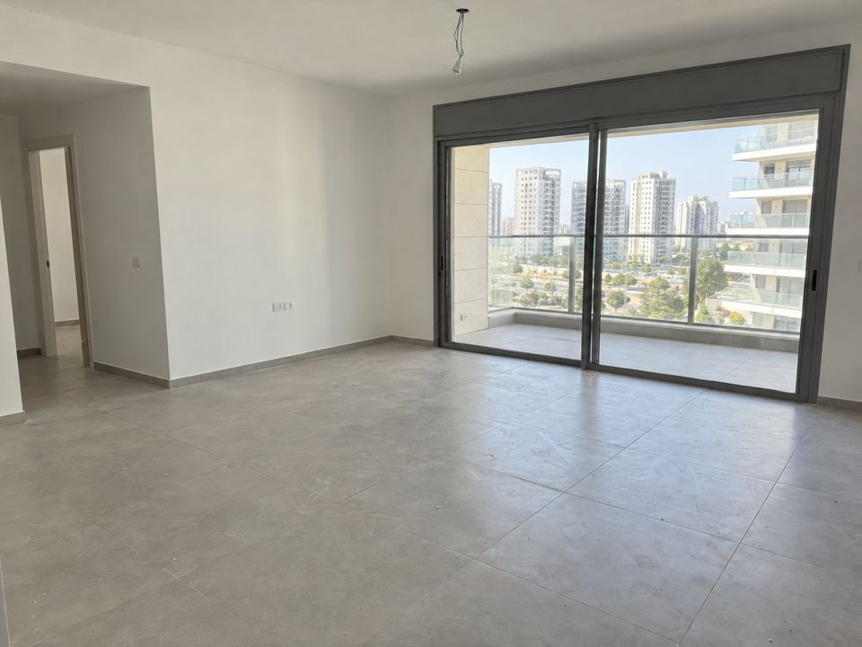 Photo of an empty living room in a new apartment before move-in